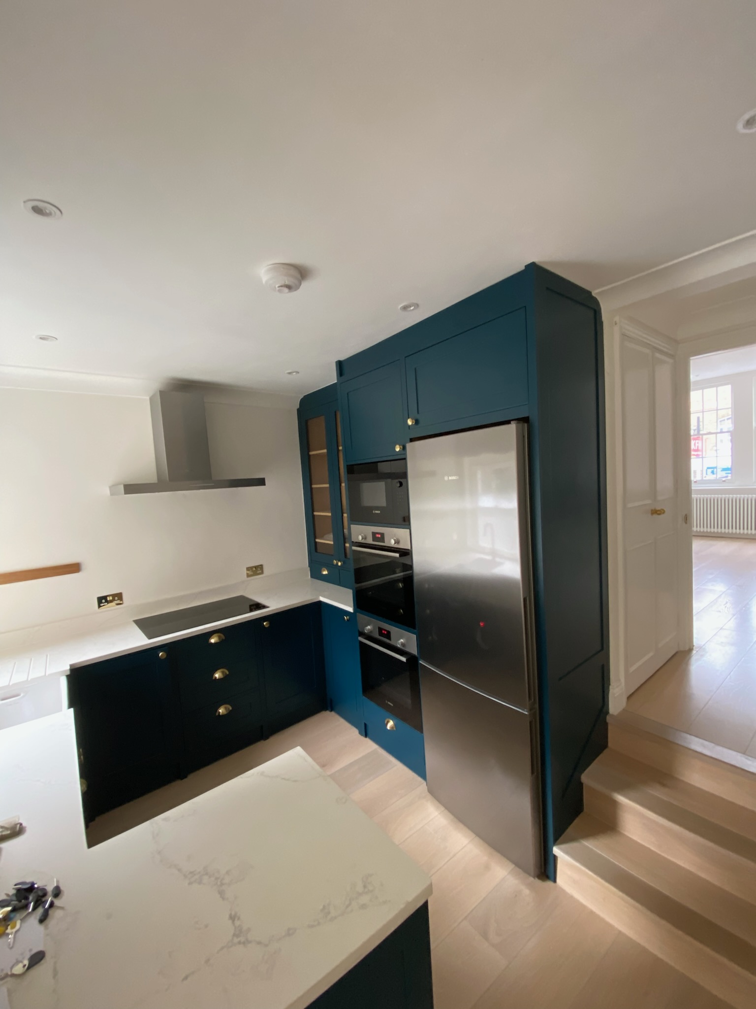 Blue fitted kitchen installation by Loyalty Construction